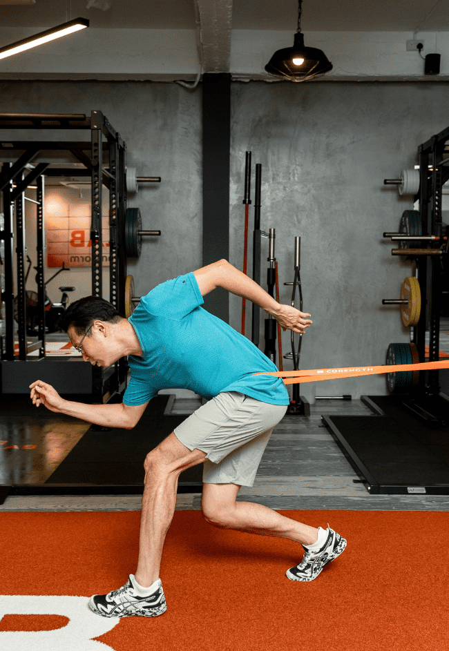 Blue shirt man leaning down about to run